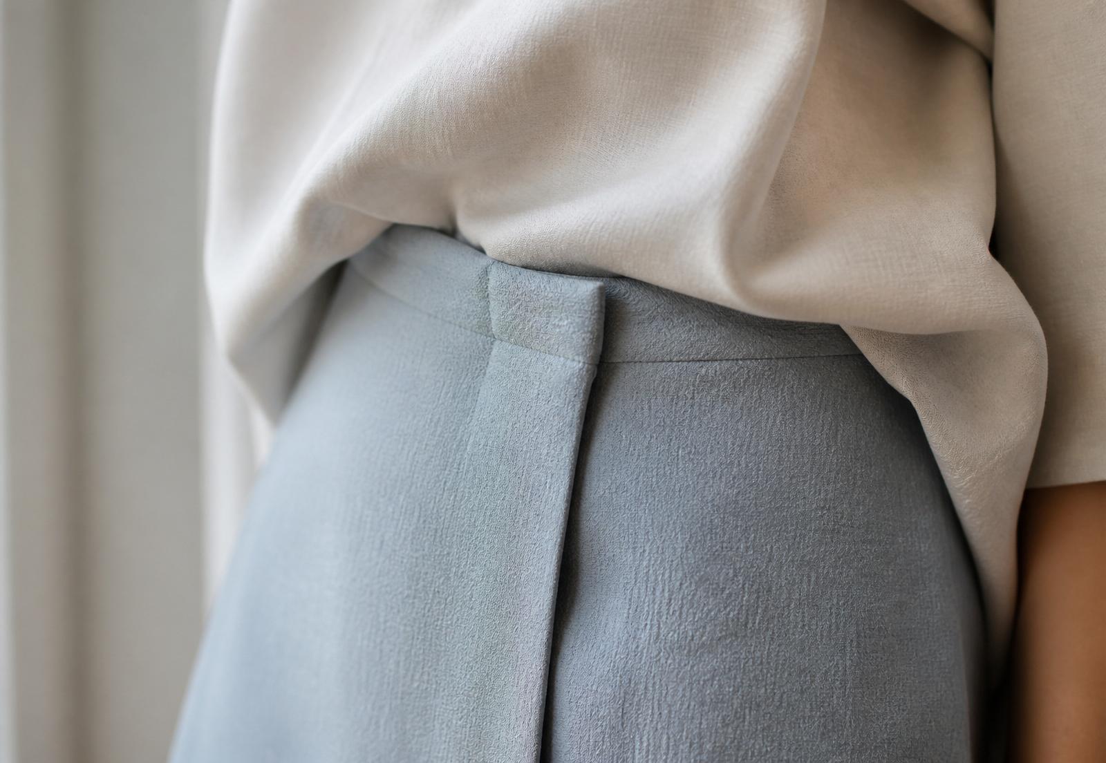 Close crop of a garment fold at the waist.
